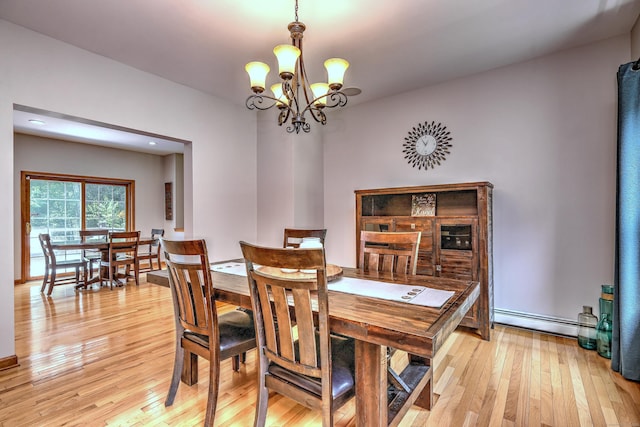 330 Webb Cir, Monroe, CT 06468 - dining area with a chandelier, light wood-style flooring, and a baseboard radiator