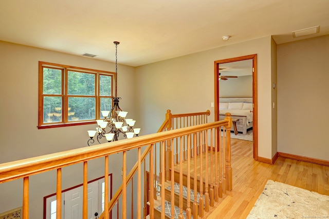 330 Webb Cir, Monroe, CT 06468 - corridor with an upstairs landing, a chandelier, and light wood-type flooring