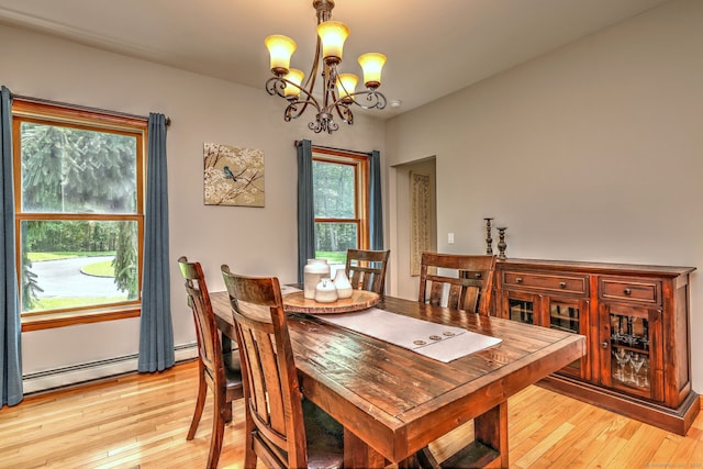 330 Webb Cir, Monroe, CT 06468 - dining area featuring a chandelier, light wood-type flooring, and a baseboard heating unit