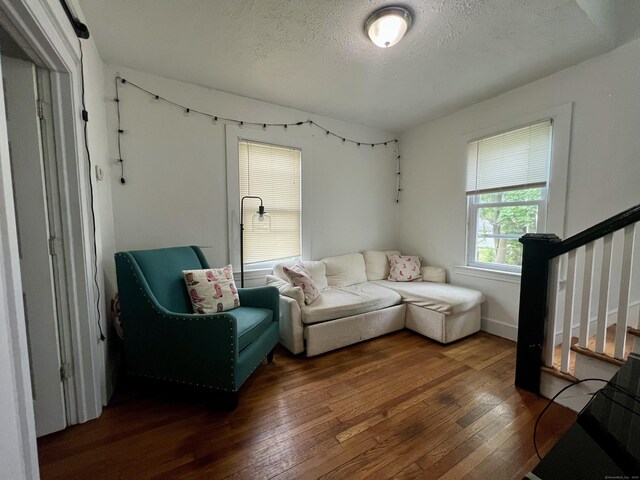 71 Forest Rd, West Haven, CT 06516 - living room with hardwood / wood-style flooring, stairway, and a textured ceiling