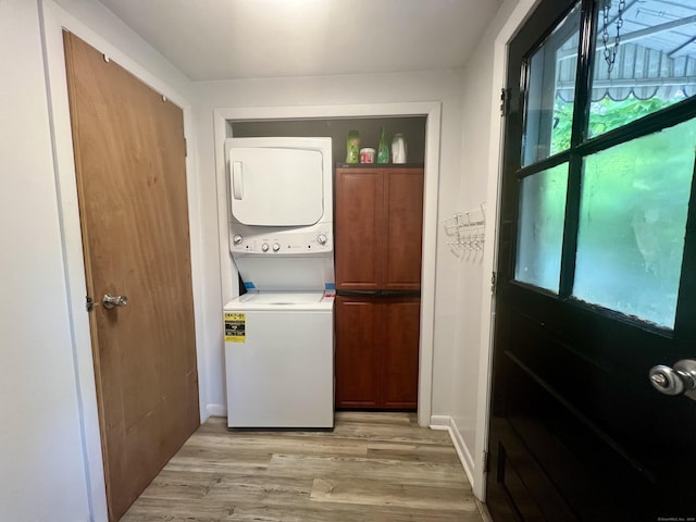 71 Forest Rd, West Haven, CT 06516 - laundry room featuring cabinet space, stacked washer and clothes dryer, and light wood finished floors