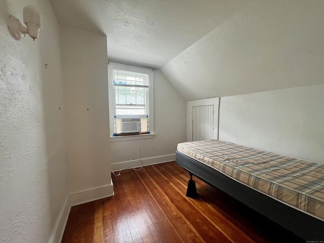 71 Forest Rd, West Haven, CT 06516 - bedroom with cooling unit, lofted ceiling, dark wood finished floors, and a textured ceiling