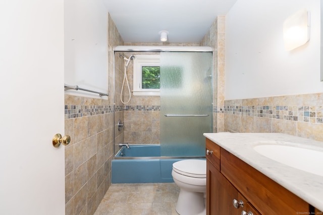 1 Boulder Rd Unit 1, Colchester, CT 06415 - full bathroom featuring tile walls, vanity, enclosed tub / shower combo, tile patterned floors, and a wainscoted wall