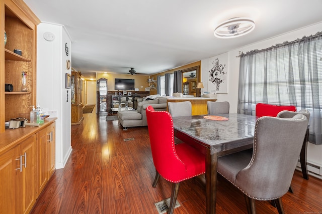 30 Brookside Dr, Southington, CT 06489 - dining space with dark wood-style flooring, a ceiling fan, and a baseboard radiator