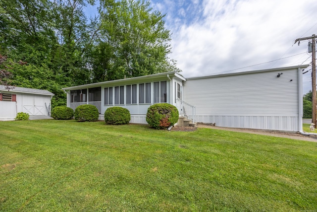 30 Brookside Dr, Southington, CT 06489 - view of front of home with a sunroom, entry steps, a front yard, and an outdoor structure