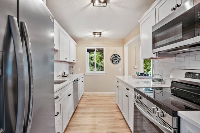 499 Heritage Vlg Unit B, Southbury, CT 06488 - kitchen with appliances with stainless steel finishes, tasteful backsplash, light wood-style flooring, light countertops, and plenty of natural light