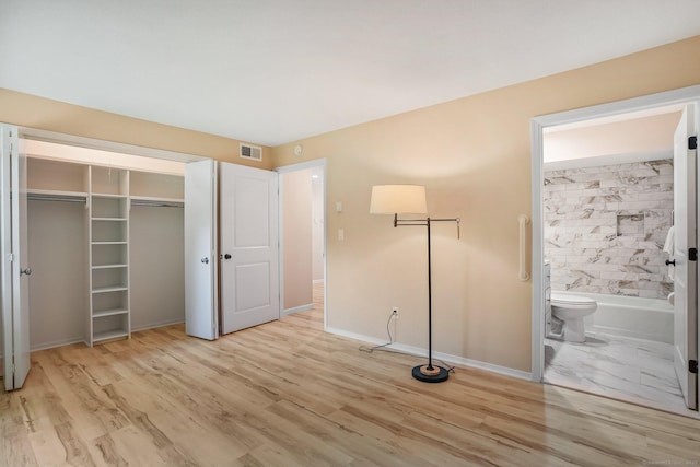 499 Heritage Vlg Unit B, Southbury, CT 06488 - unfurnished bedroom featuring wood finished floors, a closet, and ensuite bathroom