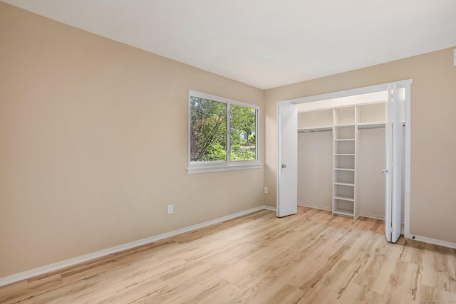 499 Heritage Vlg Unit B, Southbury, CT 06488 - unfurnished bedroom with light wood-style flooring and a closet