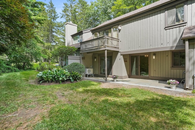 499 Heritage Vlg Unit B, Southbury, CT 06488 - rear view of property with a chimney, a balcony, a patio, and a lawn
