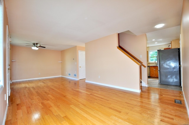19 Windy Hill Ln Unit 19, Rocky Hill, CT 06067 - unfurnished living room featuring light wood-style flooring, stairs, and ceiling fan