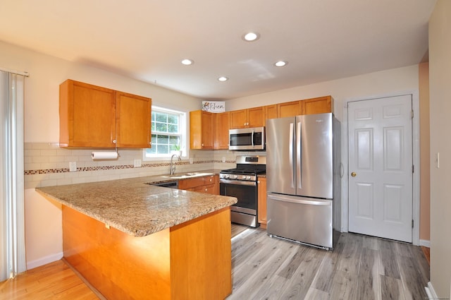 19 Windy Hill Ln Unit 19, Rocky Hill, CT 06067 - kitchen with appliances with stainless steel finishes, a peninsula, light stone counters, tasteful backsplash, and recessed lighting