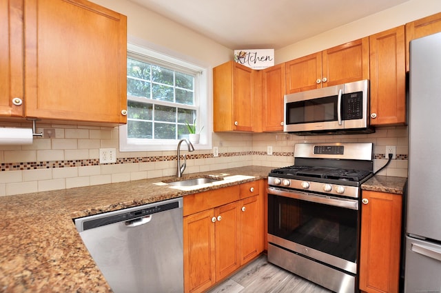 19 Windy Hill Ln Unit 19, Rocky Hill, CT 06067 - kitchen with appliances with stainless steel finishes, light wood-style flooring, tasteful backsplash, and light stone countertops