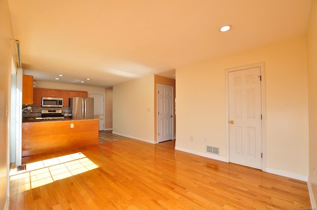 19 Windy Hill Ln Unit 19, Rocky Hill, CT 06067 - unfurnished living room featuring light wood-style flooring and recessed lighting