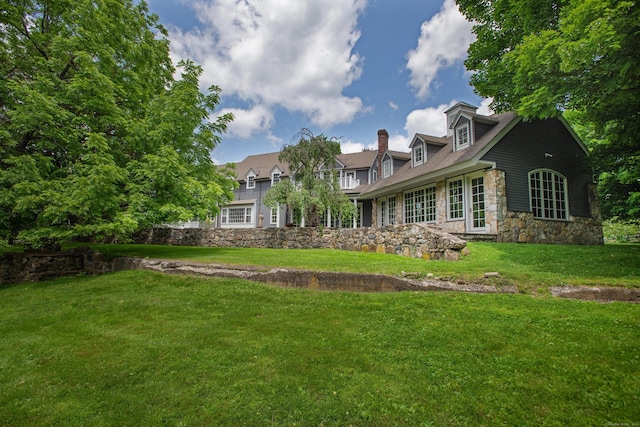 873 N Salem Rd, Ridgefield, CT 06877 - back of property with stone siding, a lawn, and a chimney