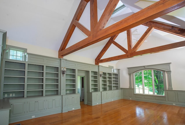 873 N Salem Rd, Ridgefield, CT 06877 - unfurnished living room with high vaulted ceiling, beam ceiling, wainscoting, wood finished floors, and a decorative wall