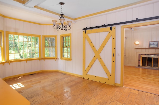 873 N Salem Rd, Ridgefield, CT 06877 - unfurnished dining area featuring hardwood / wood-style floors, a chandelier, crown molding, wooden walls, and a fireplace