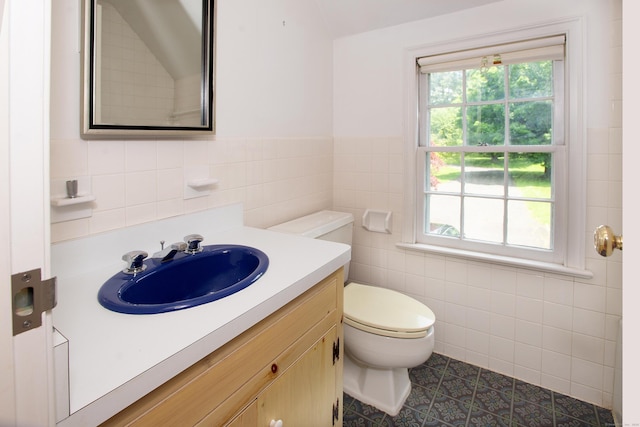 873 N Salem Rd, Ridgefield, CT 06877 - bathroom with tile walls, vanity, plenty of natural light, tile patterned flooring, and wainscoting