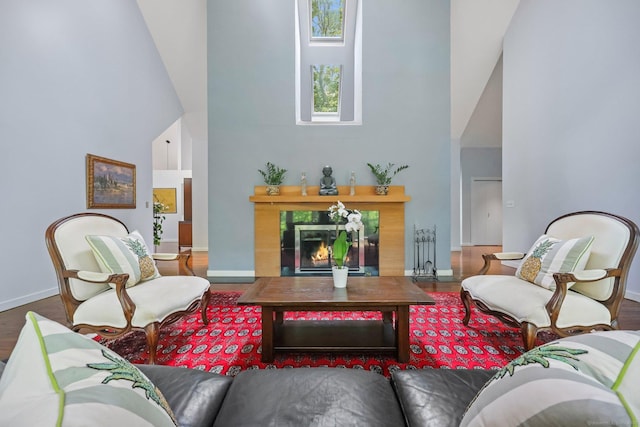 22 Blackberry Dr E, Stamford, CT 06903 - living room with high vaulted ceiling, wood finished floors, and a tile fireplace
