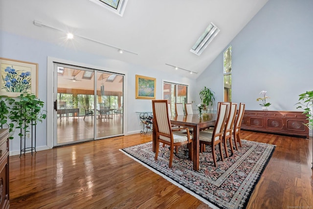 22 Blackberry Dr E, Stamford, CT 06903 - dining area featuring a skylight, rail lighting, wood finished floors, and high vaulted ceiling