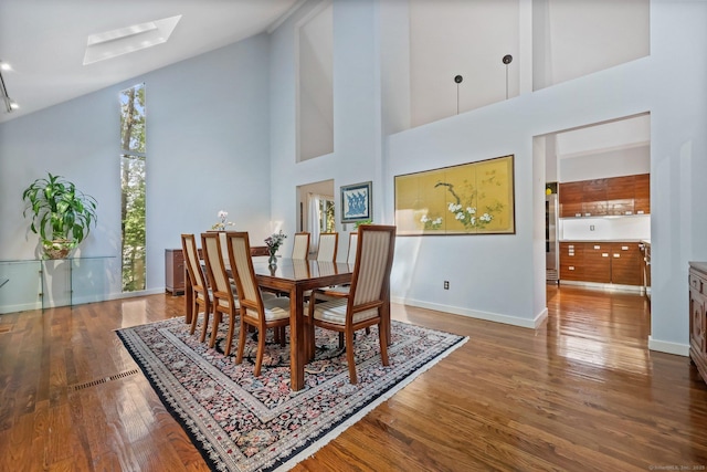 22 Blackberry Dr E, Stamford, CT 06903 - dining area featuring high vaulted ceiling, a skylight, and wood finished floors