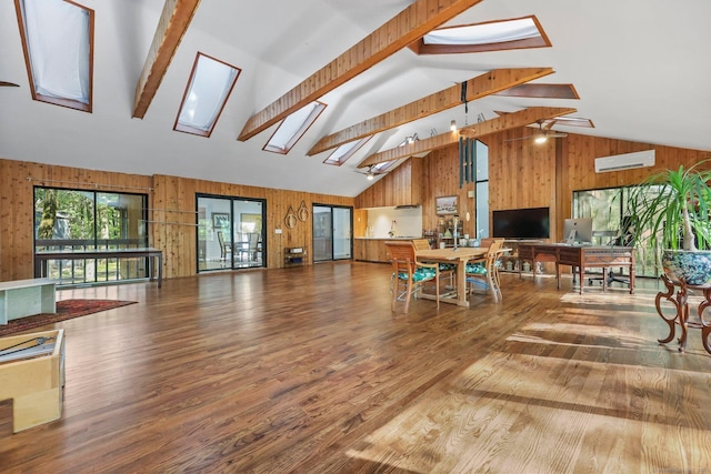 22 Blackberry Dr E, Stamford, CT 06903 - living area featuring a skylight, a wall mounted AC, wooden walls, wood finished floors, and beamed ceiling