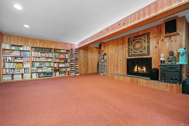 22 Blackberry Dr E, Stamford, CT 06903 - living area featuring wooden walls, a warm lit fireplace, and carpet floors