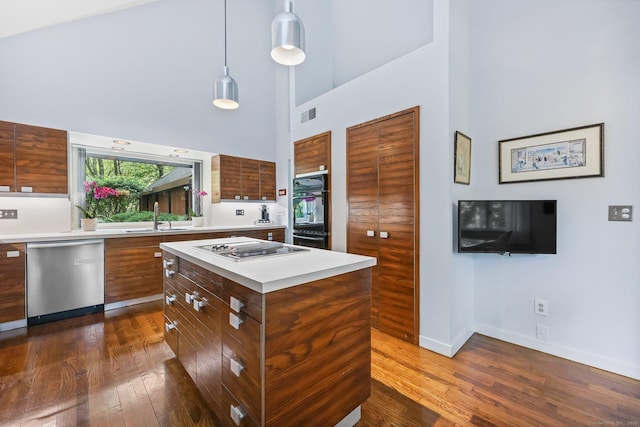 22 Blackberry Dr E, Stamford, CT 06903 - kitchen with dishwasher, a towering ceiling, modern cabinets, light countertops, and dark wood-style flooring