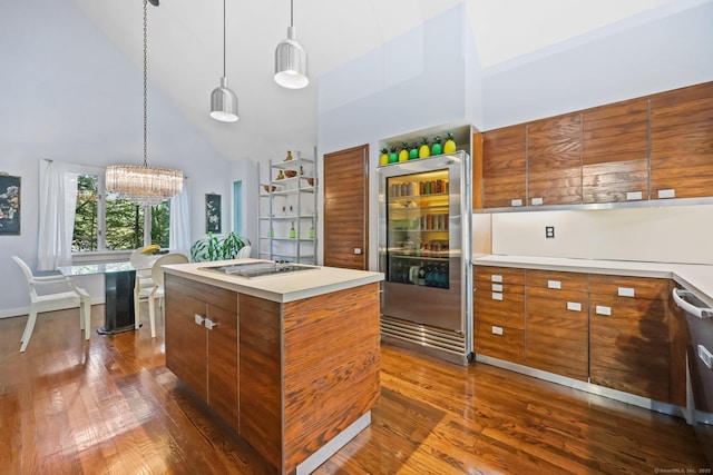 22 Blackberry Dr E, Stamford, CT 06903 - kitchen with high vaulted ceiling, wine cooler, brown cabinetry, dark wood-style flooring, and a chandelier