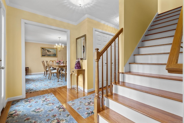 28 Fieldstone Path, Newington, CT 06111 - stairway with wood finished floors, a chandelier, and crown molding