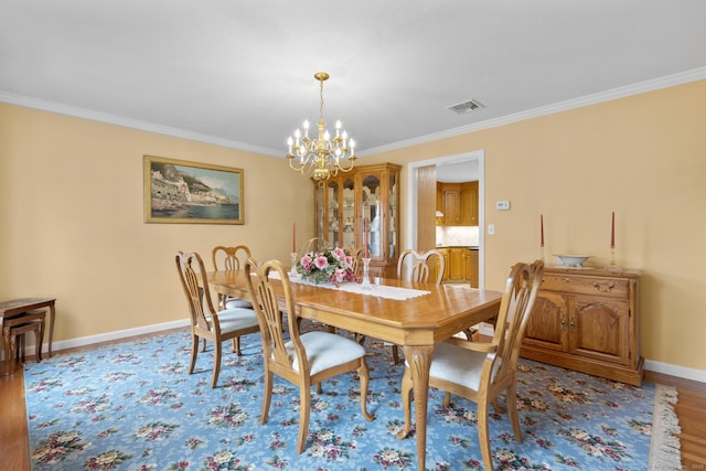 28 Fieldstone Path, Newington, CT 06111 - dining area with a chandelier, crown molding, and wood finished floors