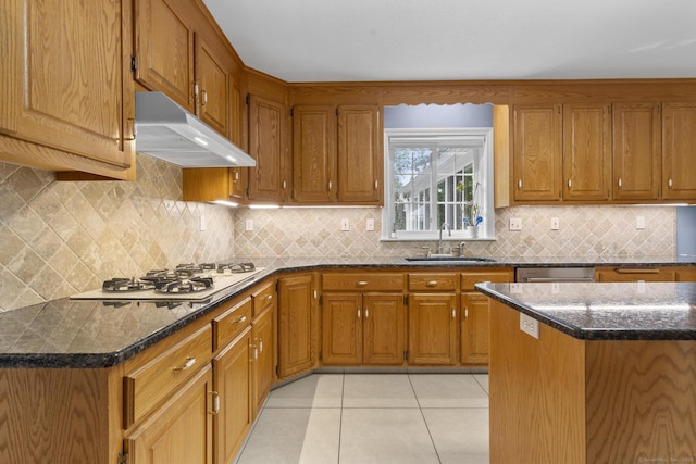 28 Fieldstone Path, Newington, CT 06111 - kitchen with under cabinet range hood, white gas cooktop, brown cabinets, light tile patterned floors, and dishwasher