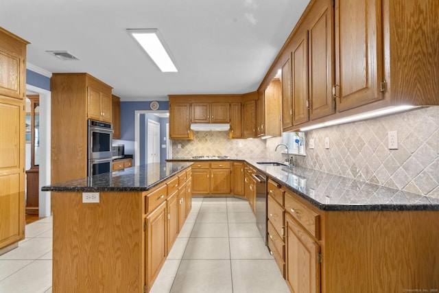 28 Fieldstone Path, Newington, CT 06111 - kitchen with stainless steel appliances, light tile patterned floors, a center island, under cabinet range hood, and backsplash