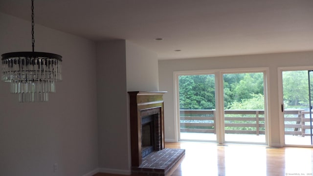 4 Rosewood Cir Unit 4, Monroe, CT 06468 - living area with wood finished floors, a fireplace, and a chandelier