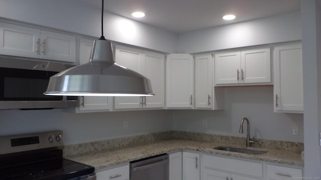 4 Rosewood Cir Unit 4, Monroe, CT 06468 - kitchen with stainless steel appliances, white cabinets, recessed lighting, decorative light fixtures, and light stone countertops