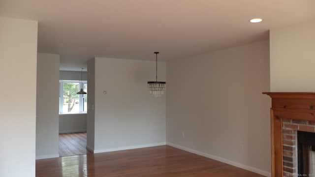 4 Rosewood Cir Unit 4, Monroe, CT 06468 - unfurnished dining area featuring wood finished floors, a brick fireplace, a chandelier, and recessed lighting