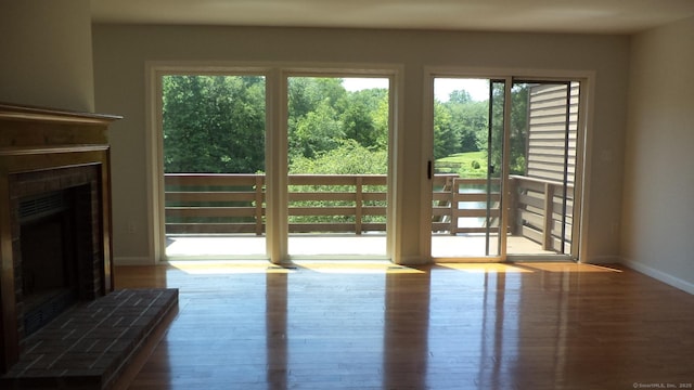 4 Rosewood Cir Unit 4, Monroe, CT 06468 - unfurnished living room with a fireplace with raised hearth and wood finished floors