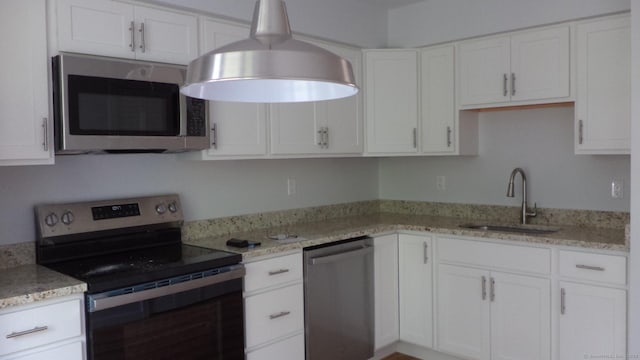 4 Rosewood Cir Unit 4, Monroe, CT 06468 - kitchen featuring stainless steel appliances, white cabinetry, and light stone countertops