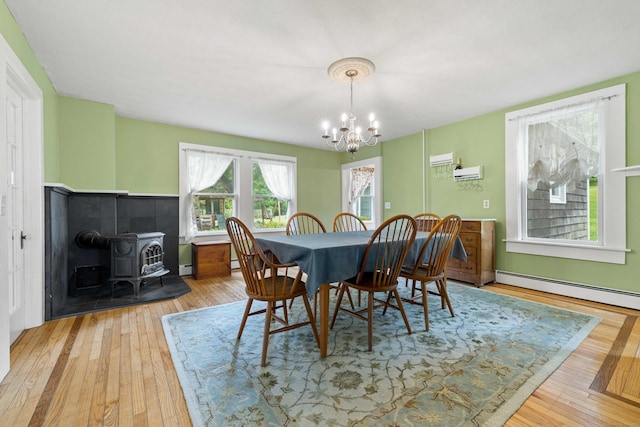 18 Cards Mill Rd, Columbia, CT 06237 - dining space with a wood stove, a chandelier, hardwood / wood-style flooring, and a baseboard heating unit