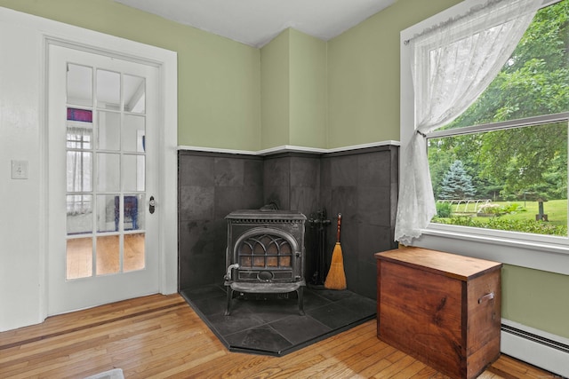 18 Cards Mill Rd, Columbia, CT 06237 - detailed view of a wood stove, a baseboard radiator, and wood finished floors