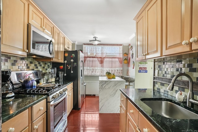 2370 N Ave Unit 5E, Bridgeport, CT 06604 - kitchen featuring appliances with stainless steel finishes, backsplash, dark stone counters, and dark wood finished floors