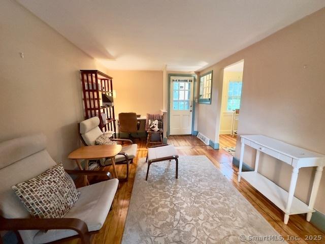 118 Sims St, Bridgeport, CT 06604 - living room featuring wood finished floors and baseboards