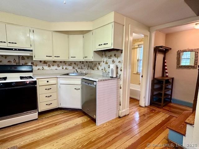 118 Sims St, Bridgeport, CT 06604 - kitchen featuring gas range oven, stainless steel dishwasher, under cabinet range hood, light wood finished floors, and light countertops