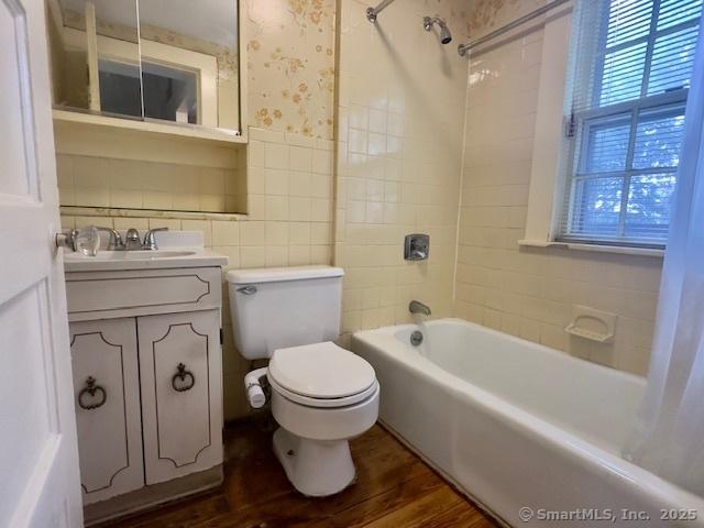118 Sims St, Bridgeport, CT 06604 - full bathroom featuring vanity, shower / bathtub combination, wood finished floors, plenty of natural light, and tile walls
