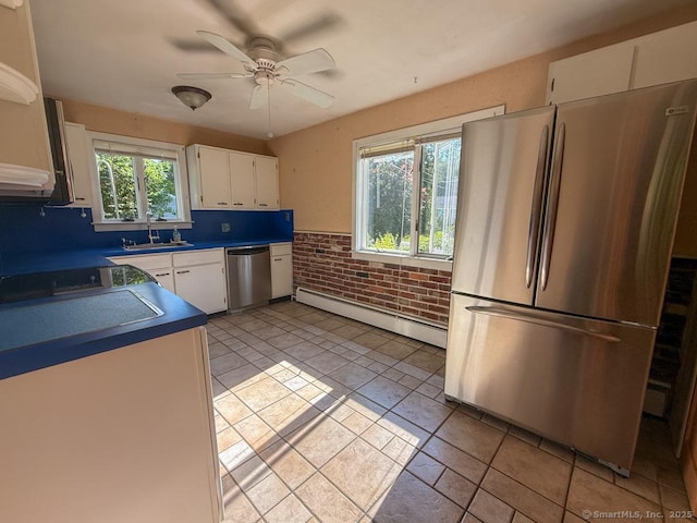 9 Meadow Brook Rd, Brookfield, CT 06804 - kitchen with stainless steel appliances, a baseboard radiator, white cabinets, a ceiling fan, and brick wall