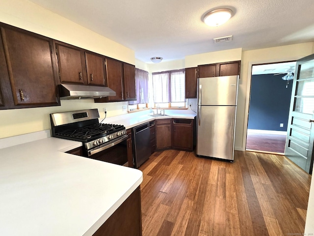 266 Cianci Rd, New Britain, CT 06053 - kitchen featuring appliances with stainless steel finishes, under cabinet range hood, light countertops, and dark wood finished floors