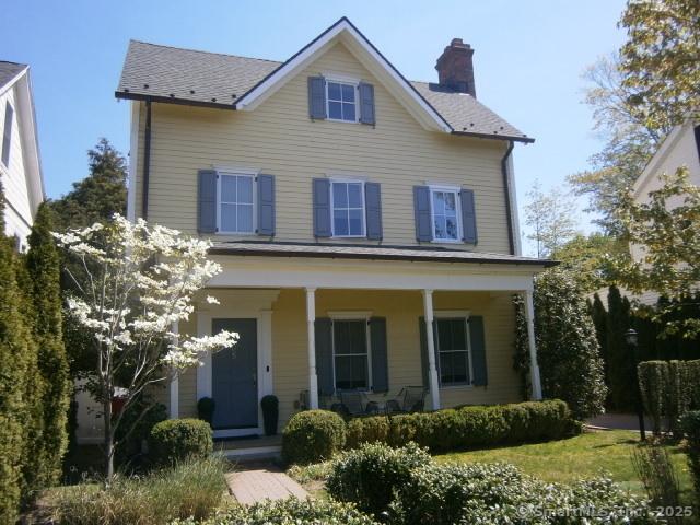 65 Sherwood Pl Unit 65, Greenwich, CT 06830 - view of front facade with covered porch and a chimney