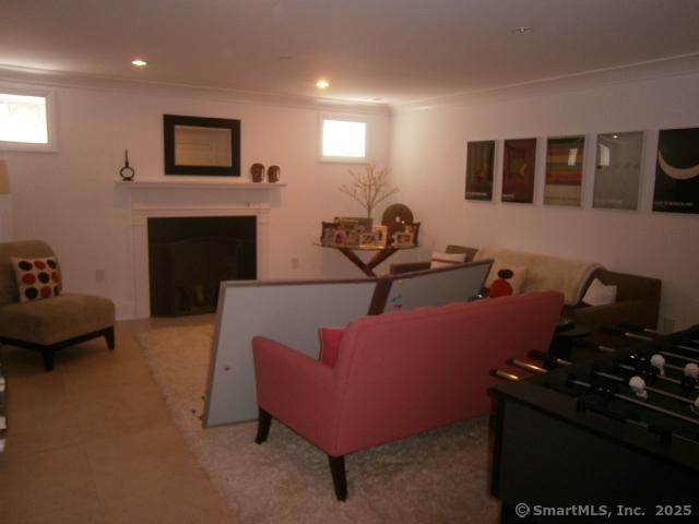 65 Sherwood Pl Unit 65, Greenwich, CT 06830 - living room with ornamental molding, a fireplace, and recessed lighting