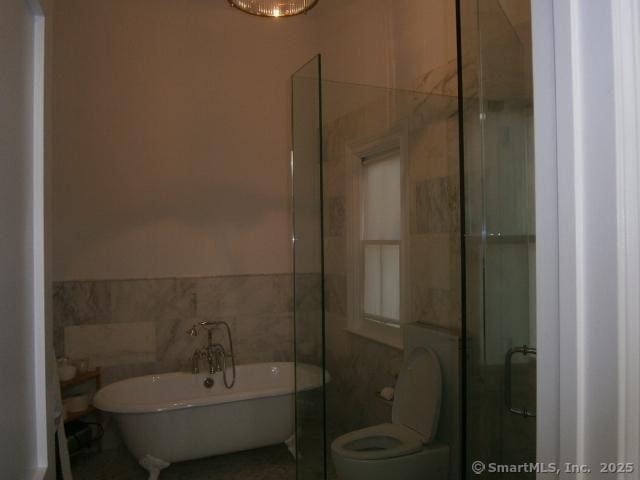 65 Sherwood Pl Unit 65, Greenwich, CT 06830 - full bathroom with tile walls, a soaking tub, and a shower stall