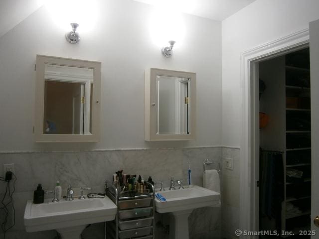 65 Sherwood Pl Unit 65, Greenwich, CT 06830 - bathroom featuring tile walls and a wainscoted wall
