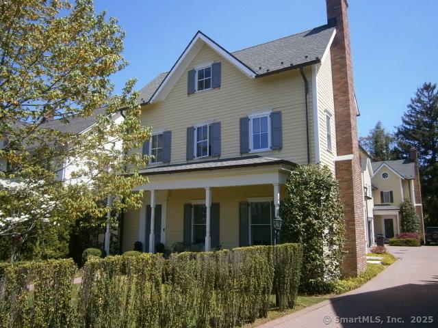 65 Sherwood Pl Unit 65, Greenwich, CT 06830 - view of front of home featuring a chimney and a porch